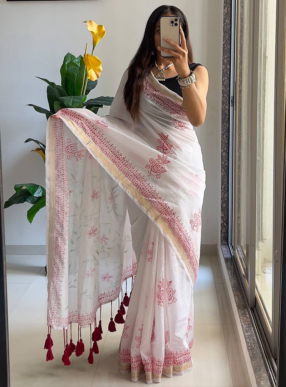 "Classic White Saree With Red Prints And Tassel Detailing"
