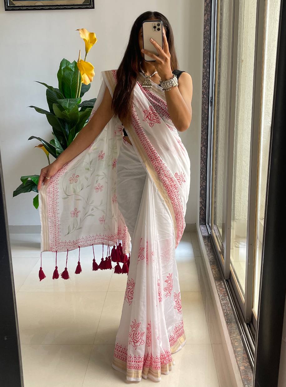 "Classic White Saree With Red Prints And Tassel Detailing"